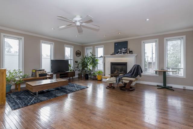 Living room: Gas fireplace and seven tall windows